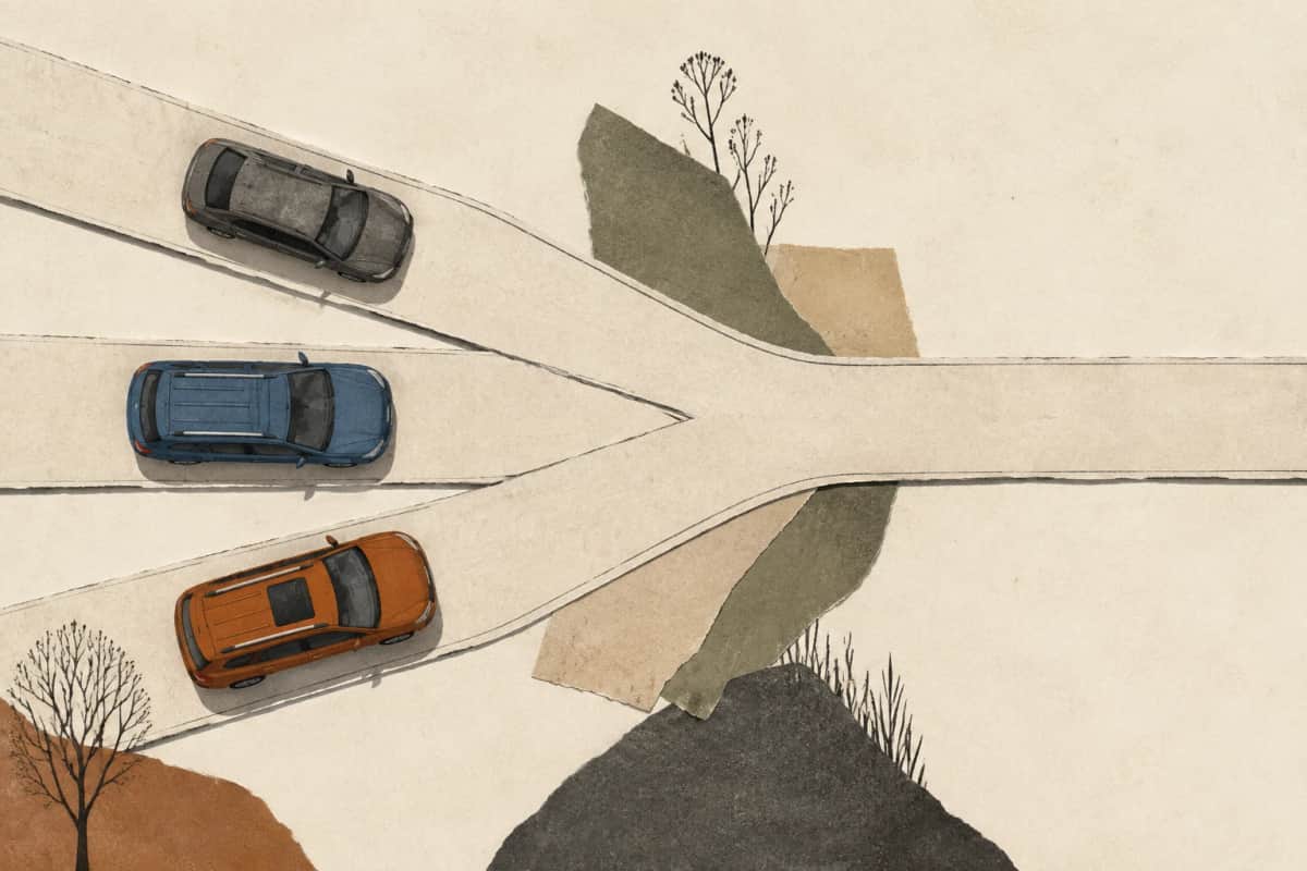 Three different cars on paper roads that converge into one route